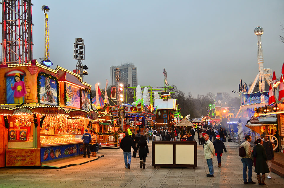 Winter Wonderland food and souvenir vendors, with people walking by
