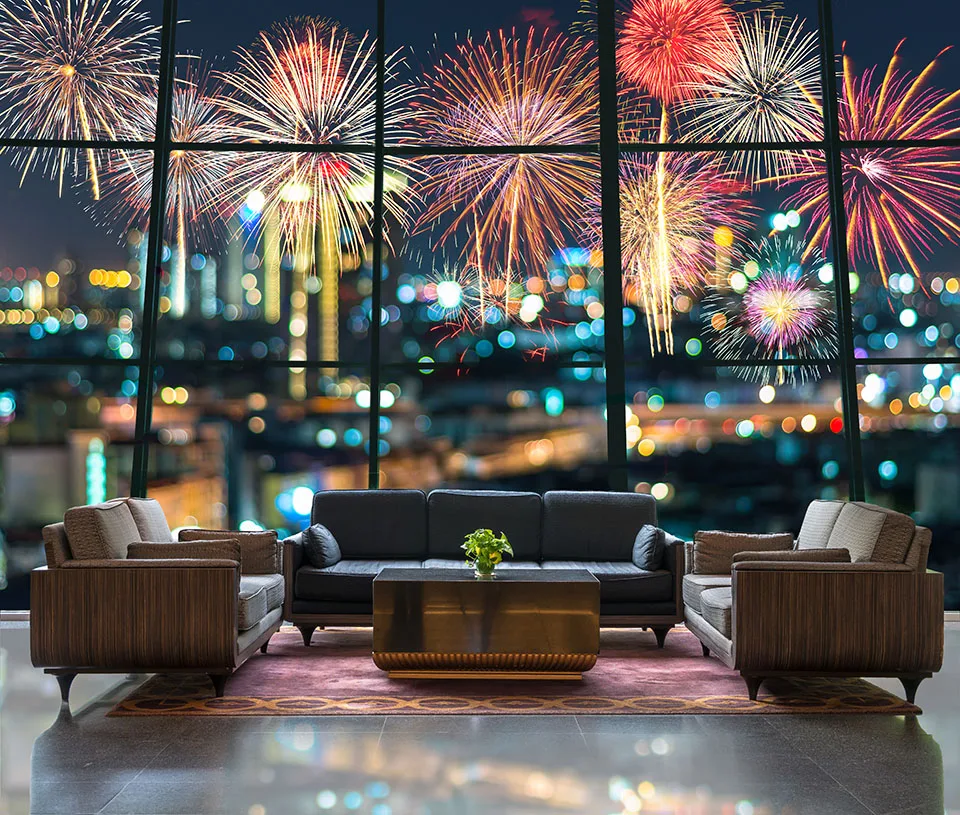 A hotel lobby along the South Bank in London, overlooking the Thames River and the NYE fireworks