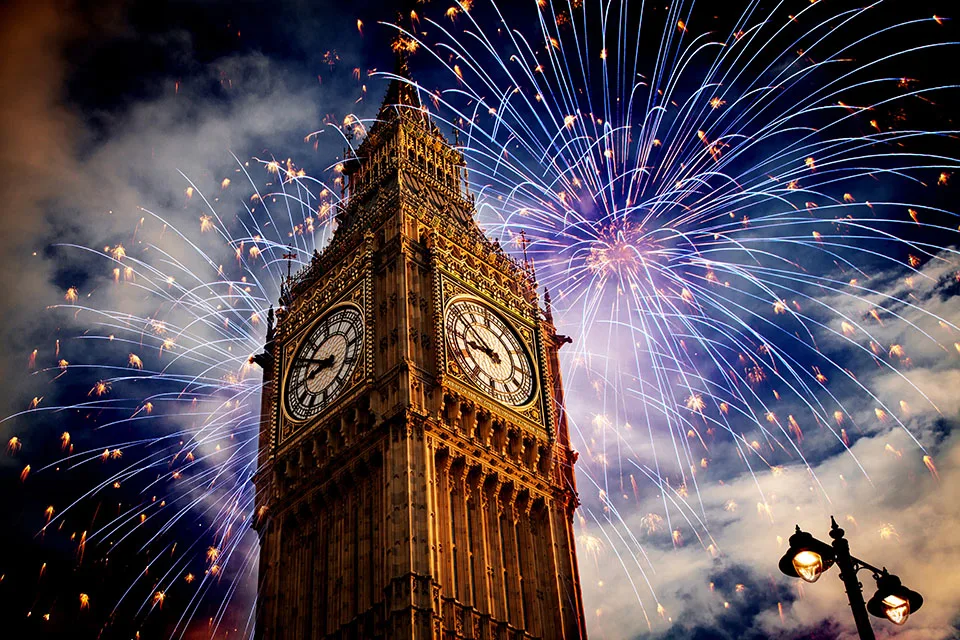 Fireworks burst in a dazzling display around Big Ben, lighting up the London skyline during a New Year's Eve celebration
