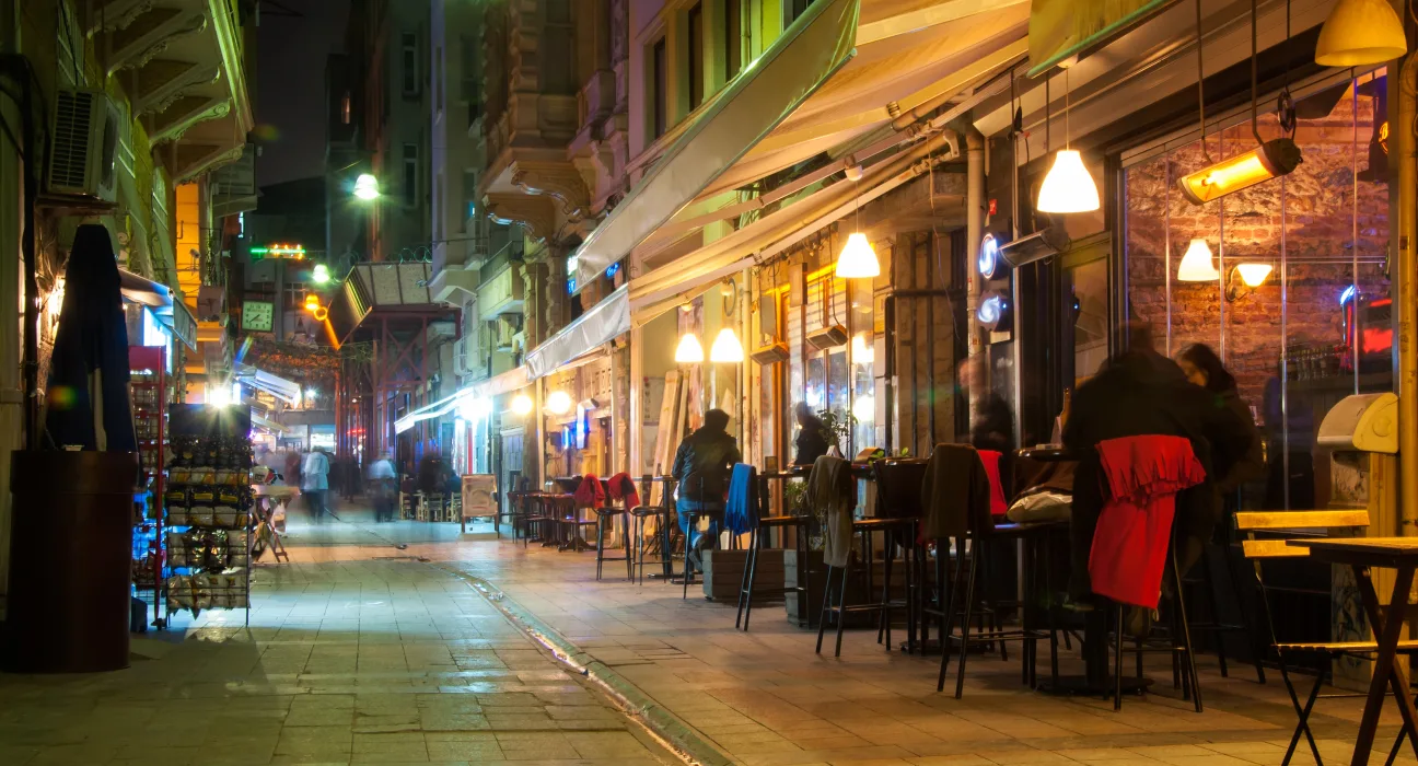 A narrow street in Istanbul with lots of restaurants and people sitting outside